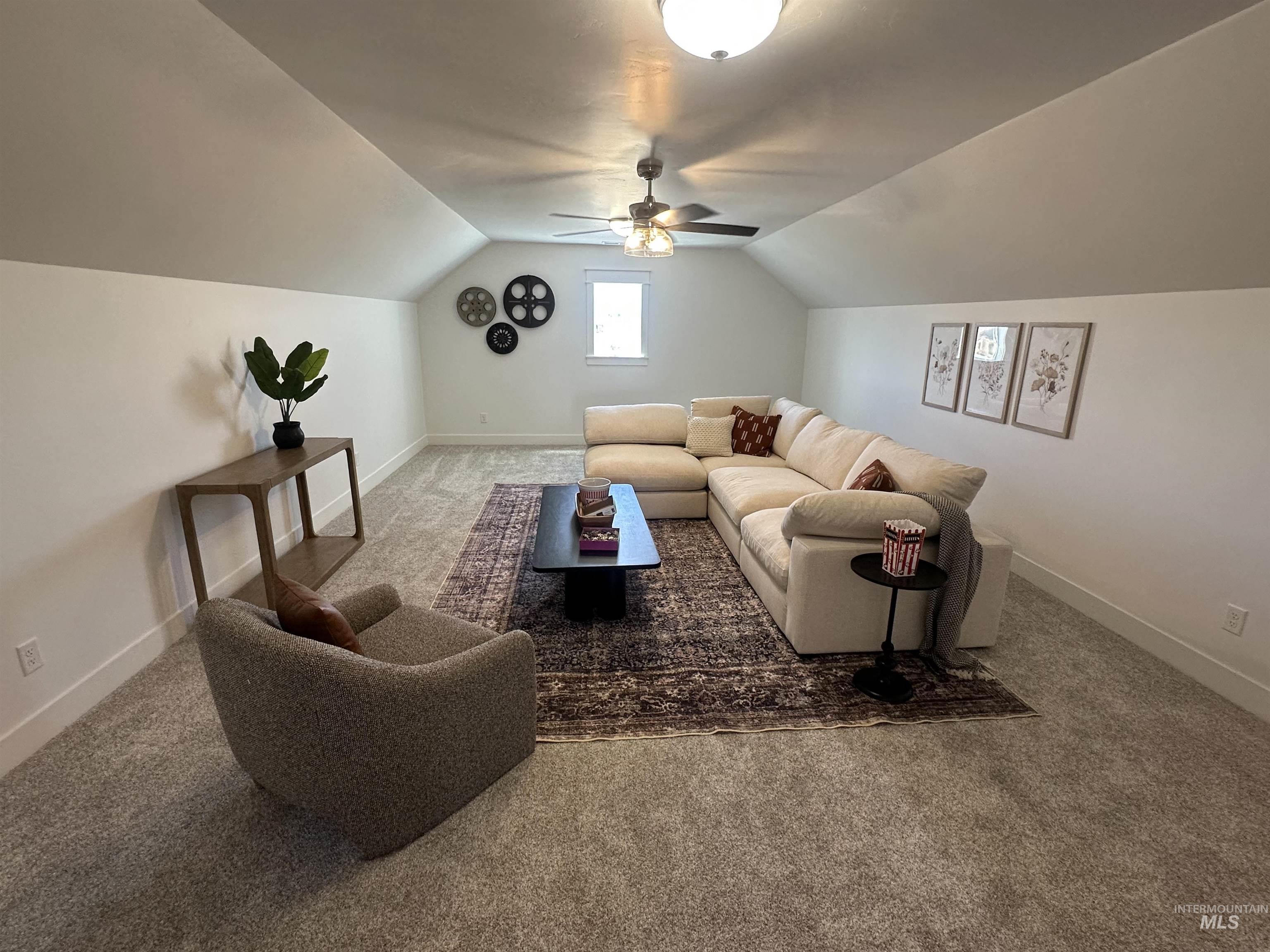 3035 Lake View Twin Falls, ID 83301 - Photo 34 of 41 Expansive carpeted room featuring a sloped ceiling, ceiling fan with integrated lighting, recessed window, and white baseboards