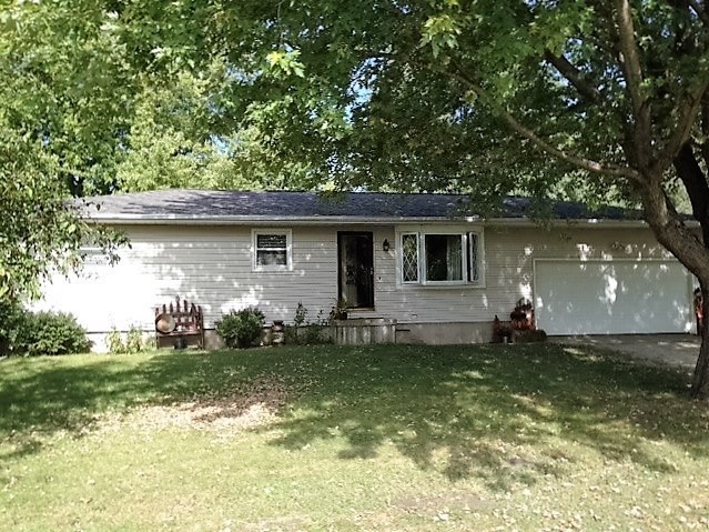 25064 Prophet Road Rock Falls, IL 61071 - Photo 1 of 22 a backyard of a house with potted plants and large tree