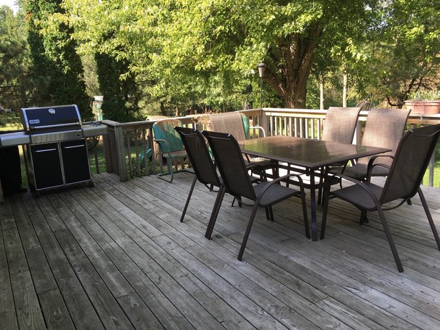 25064 Prophet Road Rock Falls, IL 61071 - Photo 14 of 22 a view of a roof deck with table and chairs with wooden floor and fence