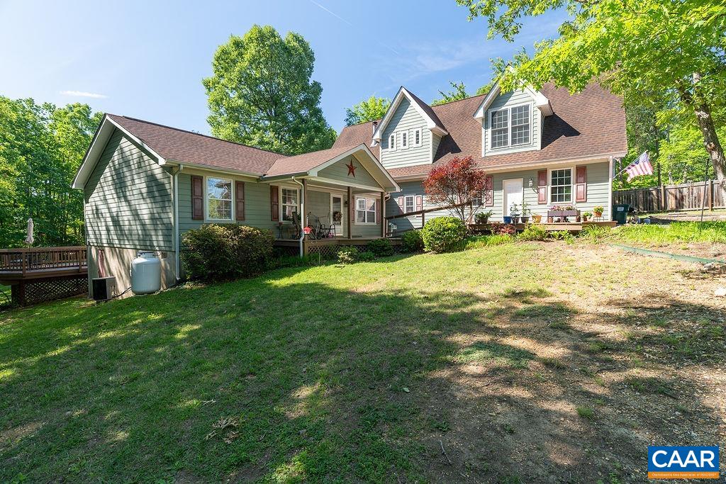 a front view of a house with yard and green space