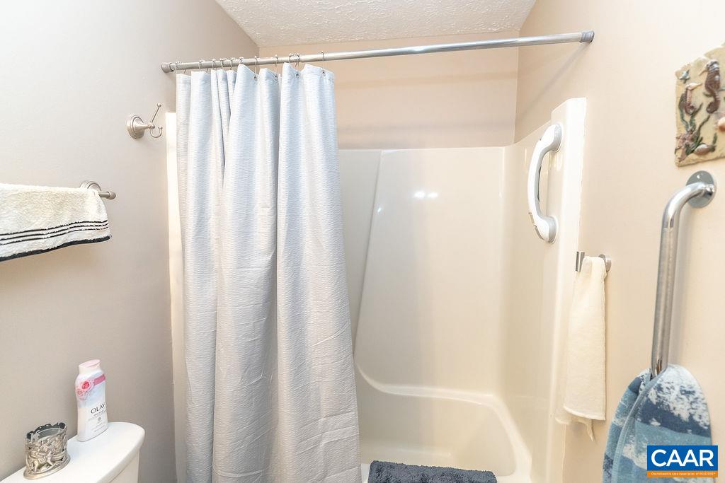2851 Martin Kings Road Scottsville, VA 24590 - Photo 11 of 67 a bathroom with a shower curtain and a window