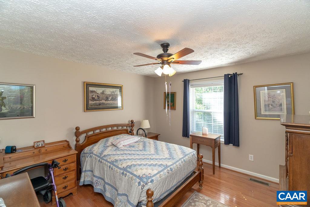 2851 Martin Kings Road Scottsville, VA 24590 - Photo 19 of 67 a bedroom with a bed and a chandelier