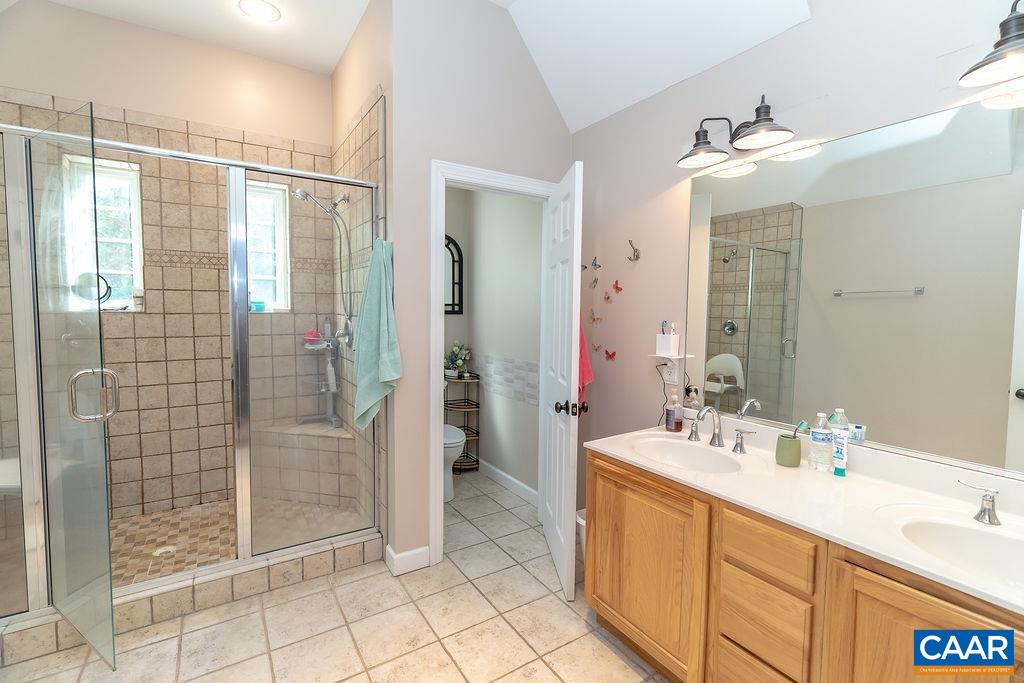 2851 Martin Kings Road Scottsville, VA 24590 - Photo 41 of 67 a bathroom with a double vanity sink mirror and shower