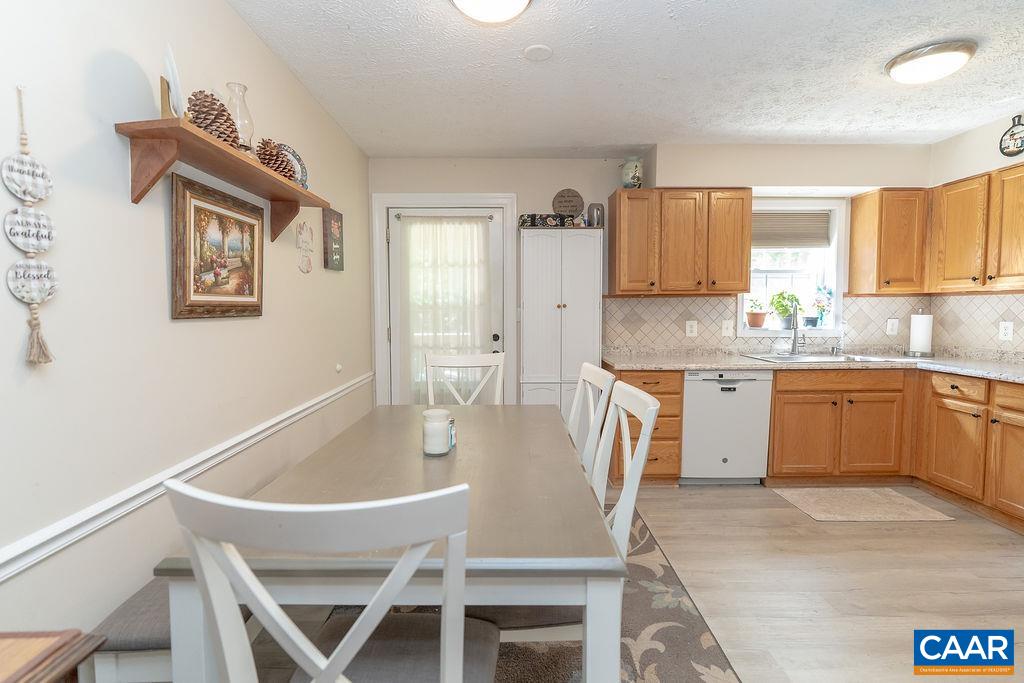 2851 Martin Kings Road Scottsville, VA 24590 - Photo 48 of 67 a kitchen with a table chairs sink and cabinets