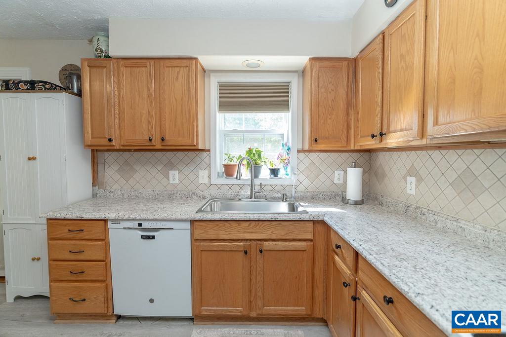 2851 Martin Kings Road Scottsville, VA 24590 - Photo 54 of 67 a kitchen with stainless steel appliances granite countertop a sink a stove and cabinets