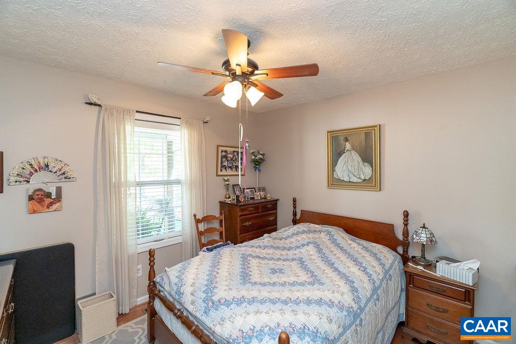 2851 Martin Kings Road Scottsville, VA 24590 - Photo 7 of 67 a bedroom with a bed and a chandelier