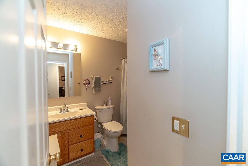 2851 Martin Kings Road Scottsville, VA 24590 - Photo 10 of 67 a bathroom with a toilet sink and mirror