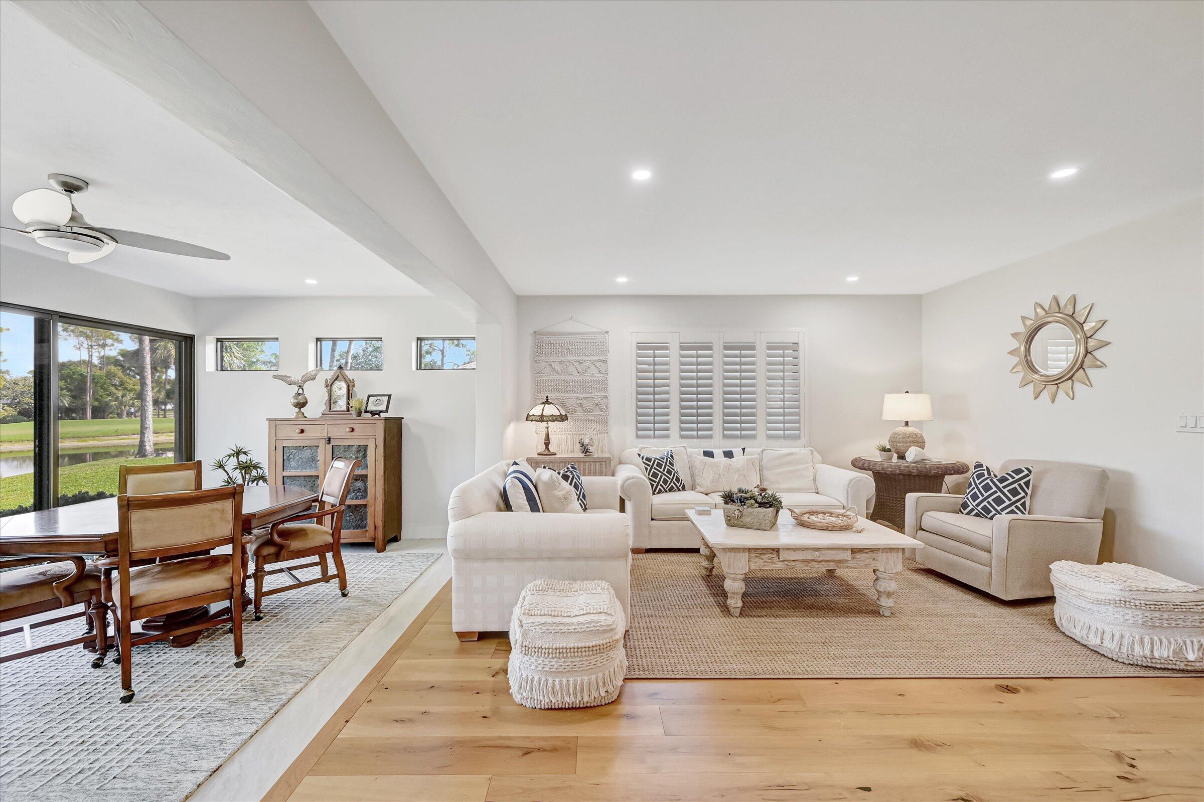 535 Augusta Boulevard, Unit 4 Naples, FL 34113 - Photo 13 of 44 a living room with furniture and a wooden floor