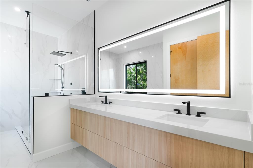 2414 Bayshore Road Nokomis, FL 34275 - Photo 26 of 64 a bathroom with a sink and a mirror