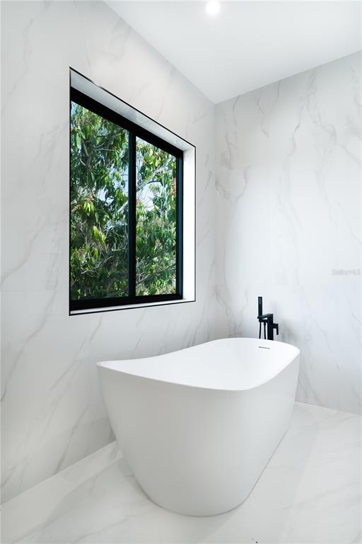 2414 Bayshore Road Nokomis, FL 34275 - Photo 28 of 64 a white bath tub sitting in a bathroom