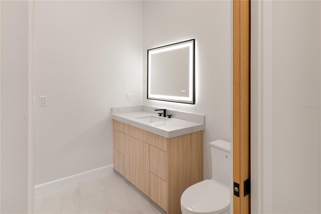 2414 Bayshore Road Nokomis, FL 34275 - Photo 34 of 64 a bathroom with a sink and a mirror