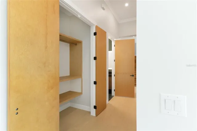 a view of a small space with wooden floor and a window