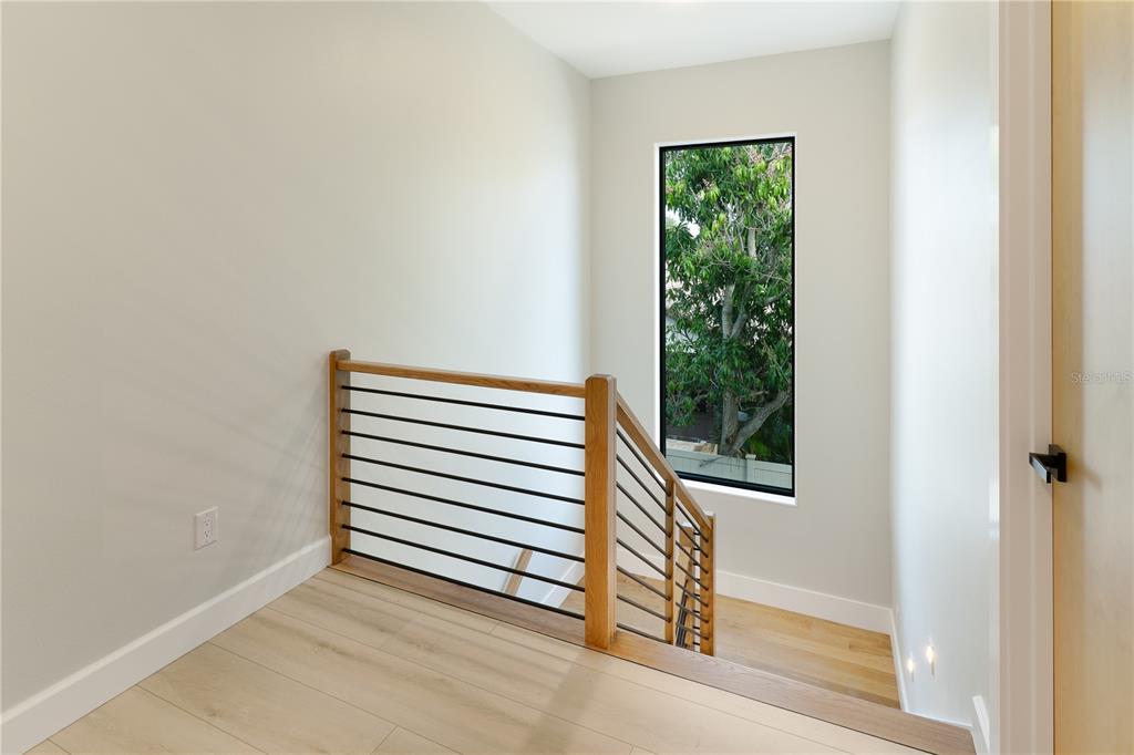 2414 Bayshore Road Nokomis, FL 34275 - Photo 51 of 64 a view of a small space with wooden floor and a window