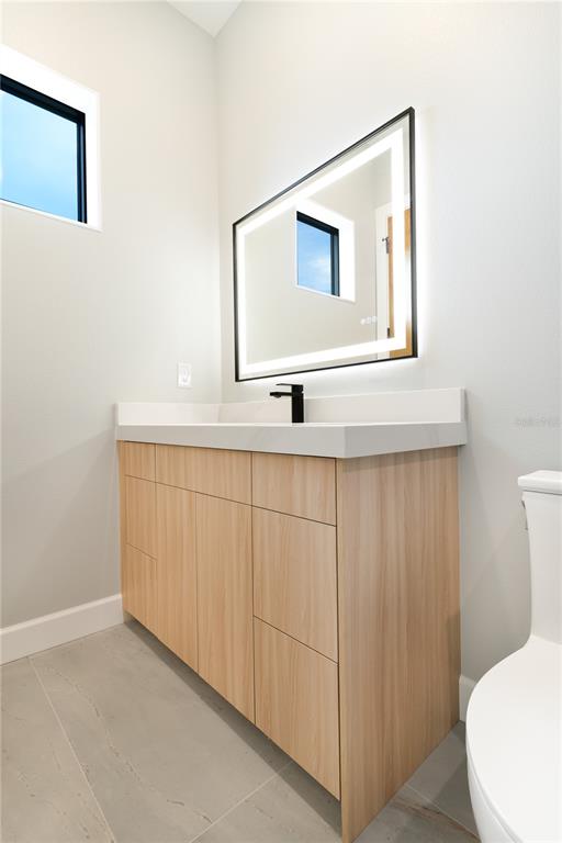 2414 Bayshore Road Nokomis, FL 34275 - Photo 57 of 64 a bathroom with a sink a toilet and mirror