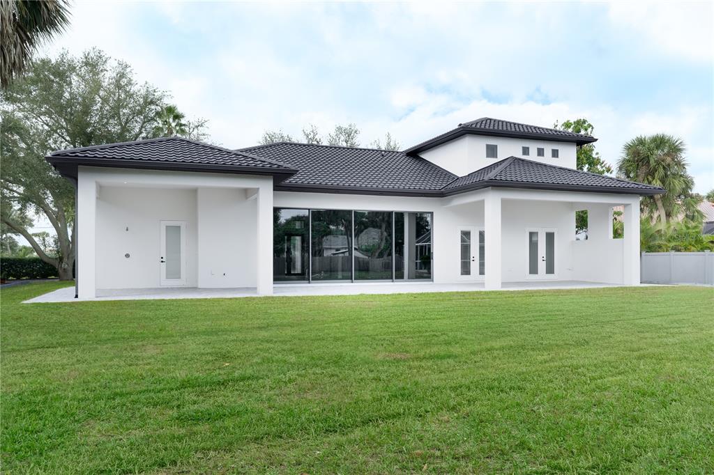 2414 Bayshore Road Nokomis, FL 34275 - Photo 60 of 64 a front view of a house with a garden