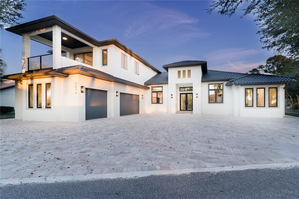 2414 Bayshore Road Nokomis, FL 34275 - Photo 62 of 64 a front view of a house with garage