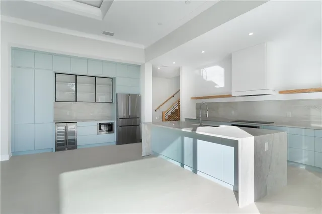 a kitchen with stainless steel appliances a refrigerator and a sink
