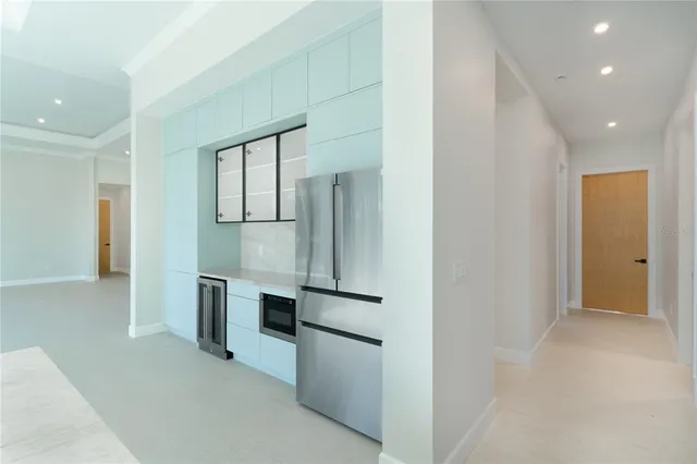 a kitchen with a sink dishwasher a stove and a refrigerator with wooden floor