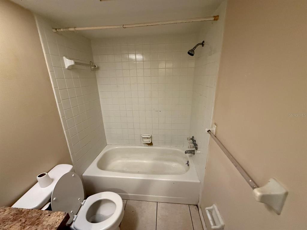 417 Century Boulevard, Unit C Auburndale, FL 33823 - Photo 2 of 5 a bathroom with a sink a toilet and shower