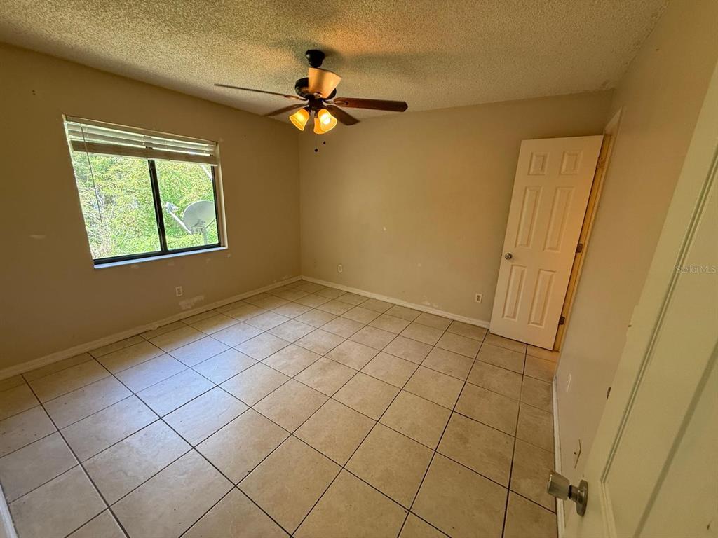 417 Century Boulevard, Unit C Auburndale, FL 33823 - Photo 5 of 5 a view of an empty room with a window