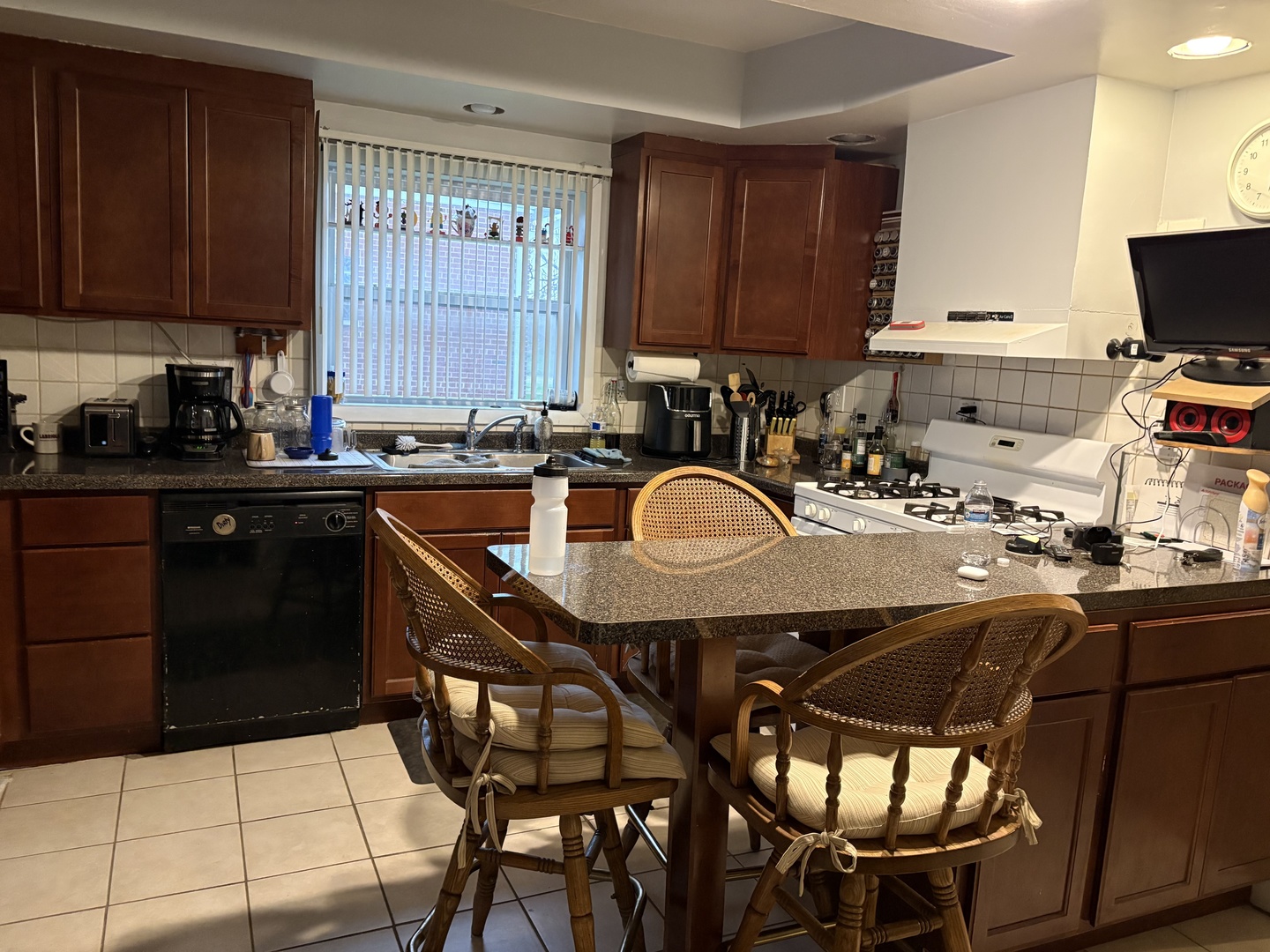 980 County Line Road Bensenville, IL 60106 - Photo 4 of 6 a kitchen with a sink a stove and wooden cabinets
