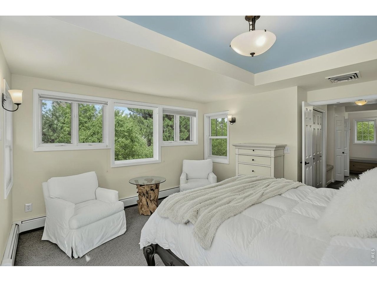 1875 Lehigh Street Boulder, CO 80305 - Photo 19 of 47 a bedroom with a large bed and a chandelier