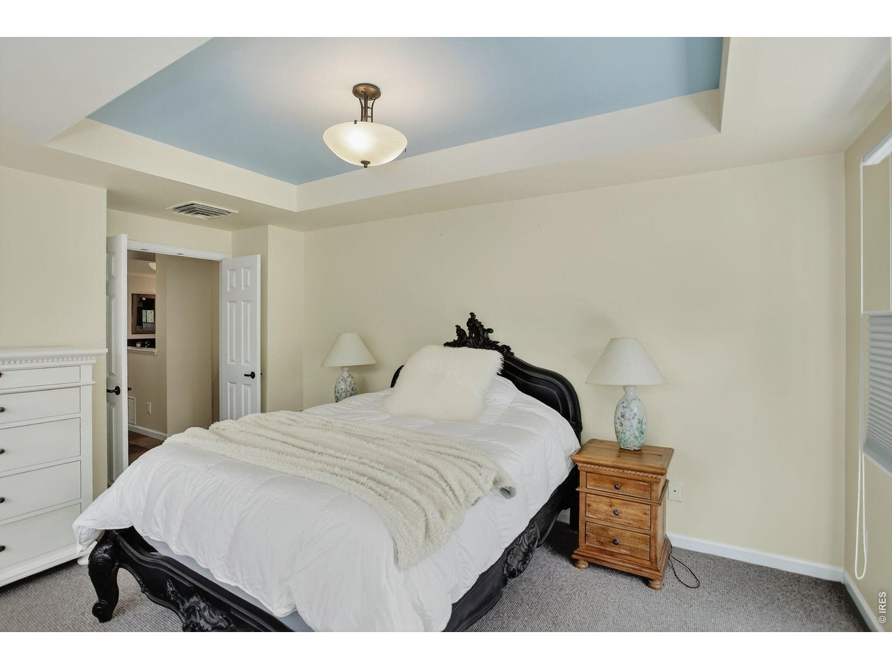 1875 Lehigh Street Boulder, CO 80305 - Photo 20 of 47 a bedroom with a bed and a chandelier