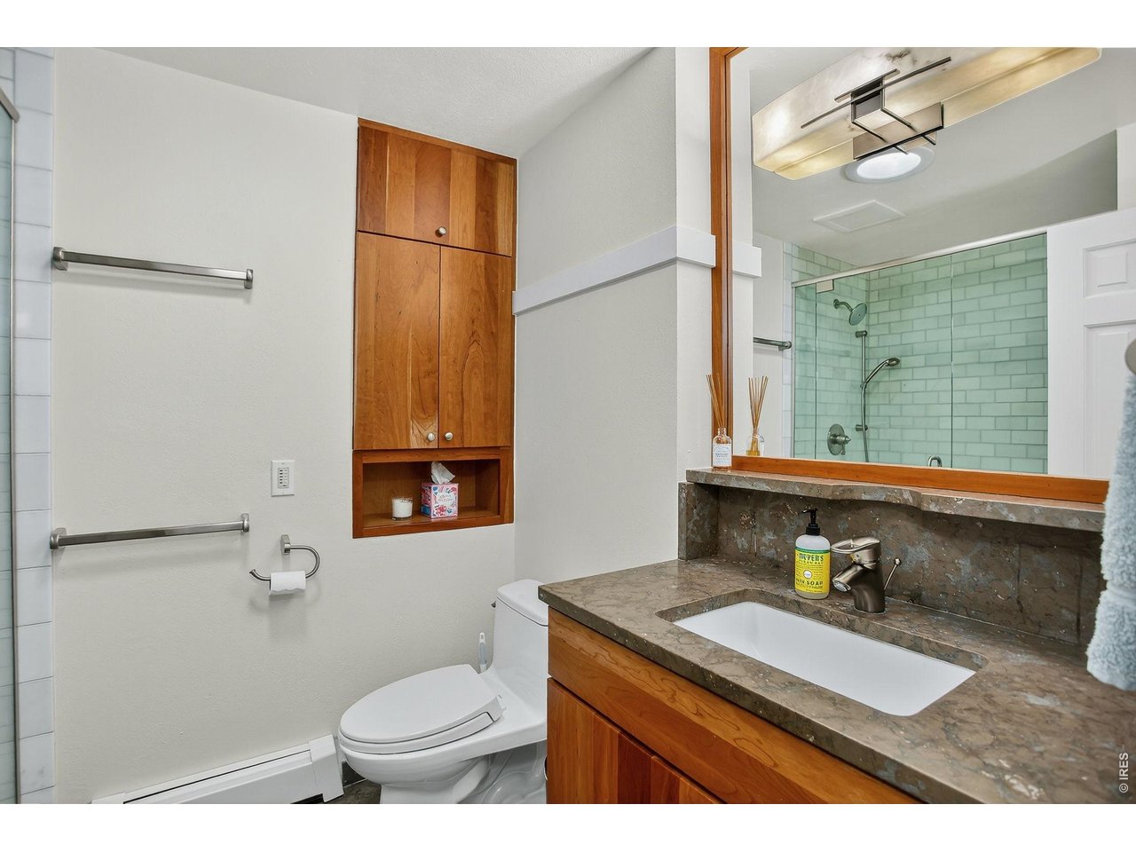 1875 Lehigh Street Boulder, CO 80305 - Photo 32 of 47 a bathroom with a granite countertop sink mirror vanity and toilet
