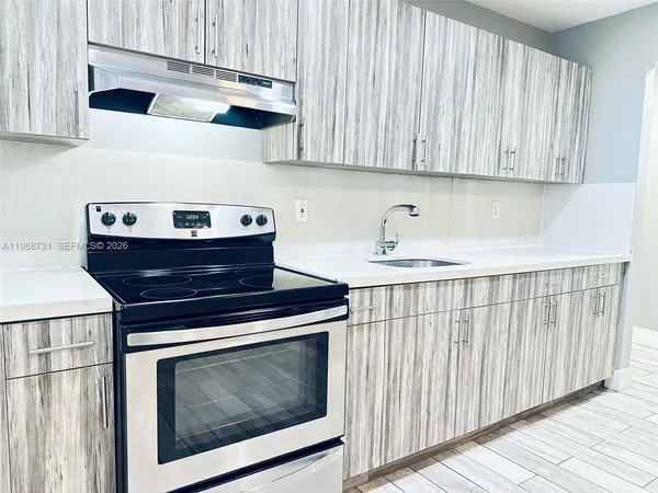 a stove top oven sitting inside of a kitchen