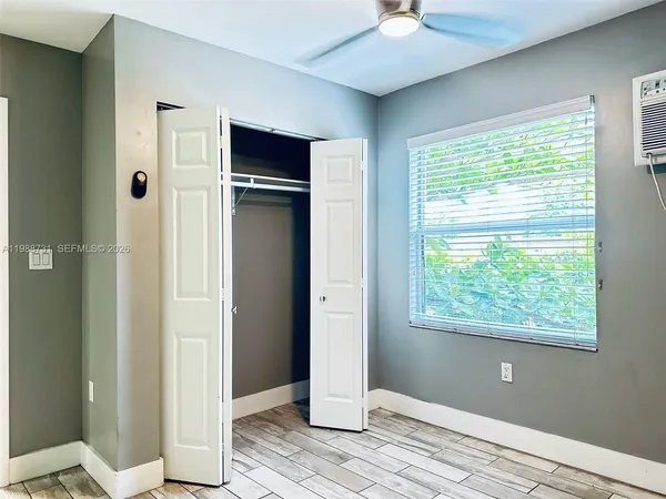a view of a livingroom with a window and wooden floor