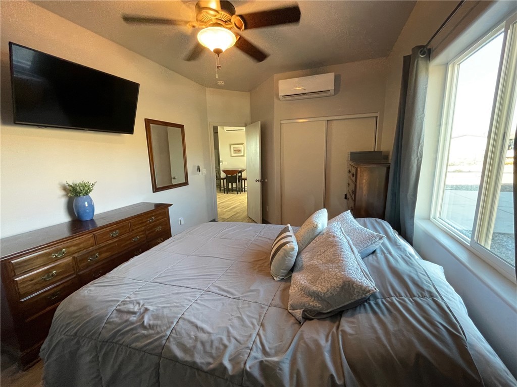 11328 Kinard Road Yucca, AZ 86438 - Photo 10 of 40 a bedroom with a bed and a flat tv screen