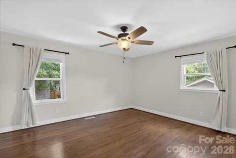 a view of a workspace with wooden floor and a window