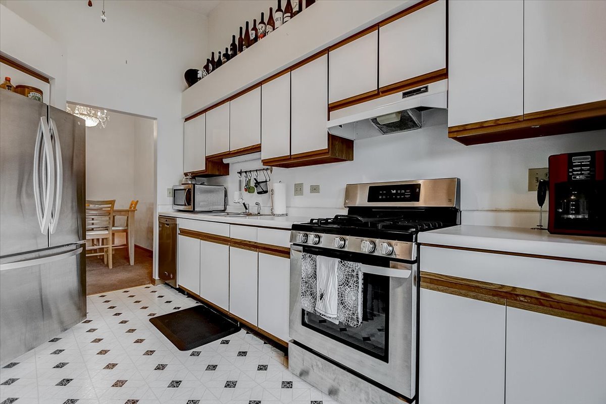 2317 Olde Mill Road Plainfield, IL 60586 - Photo 11 of 35 a kitchen with stainless steel appliances granite countertop a refrigerator a stove and a sink