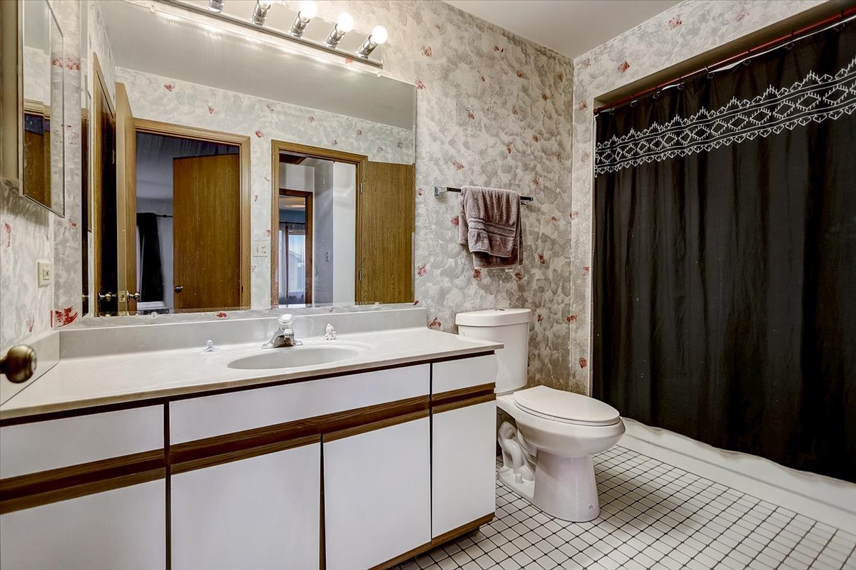 2317 Olde Mill Road Plainfield, IL 60586 - Photo 15 of 35 a bathroom with a sink a toilet a mirror and shower