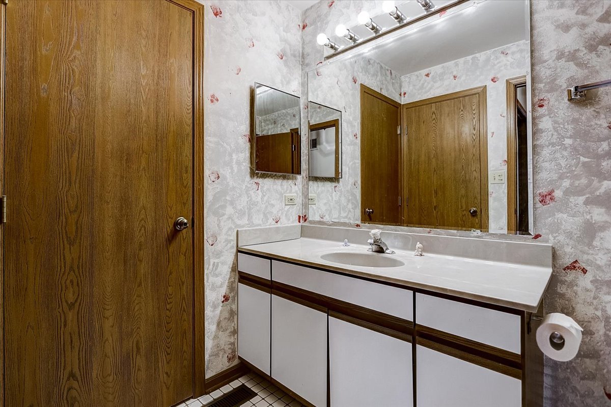 2317 Olde Mill Road Plainfield, IL 60586 - Photo 16 of 35 a bathroom with a sink and a mirror