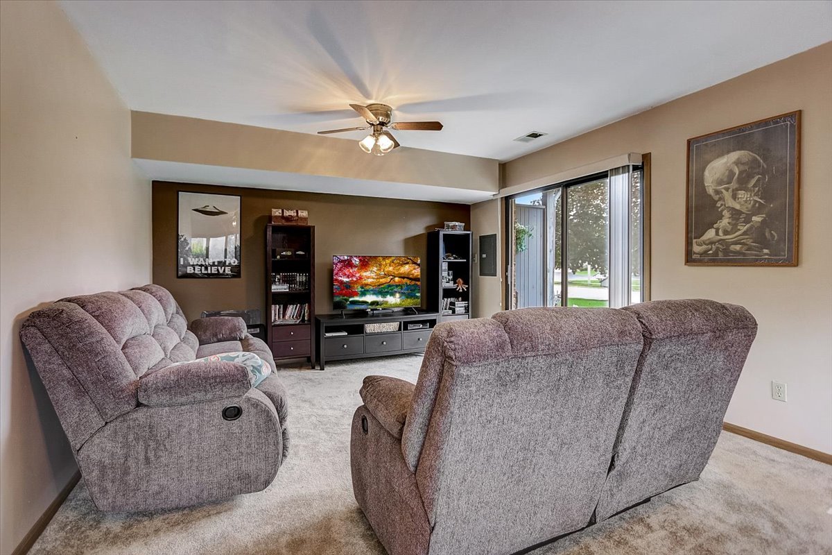 2317 Olde Mill Road Plainfield, IL 60586 - Photo 19 of 35 a living room with furniture and a flat screen tv