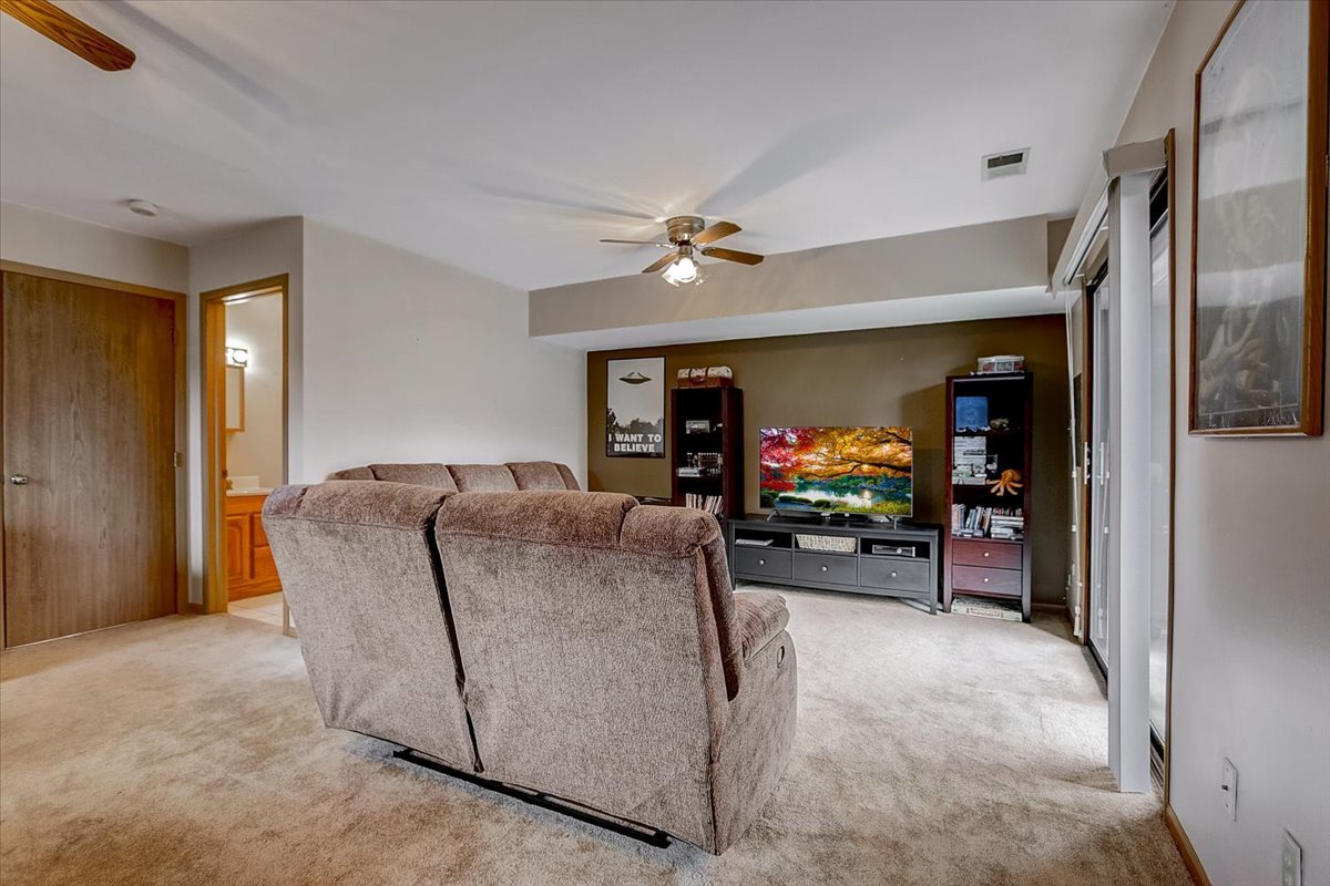 2317 Olde Mill Road Plainfield, IL 60586 - Photo 21 of 35 a living room with furniture and a flat screen tv