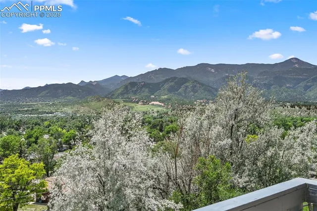 a view of a mountain range with trees in the background