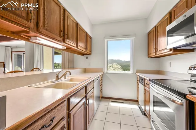 a kitchen with stainless steel appliances granite countertop a sink and a stove