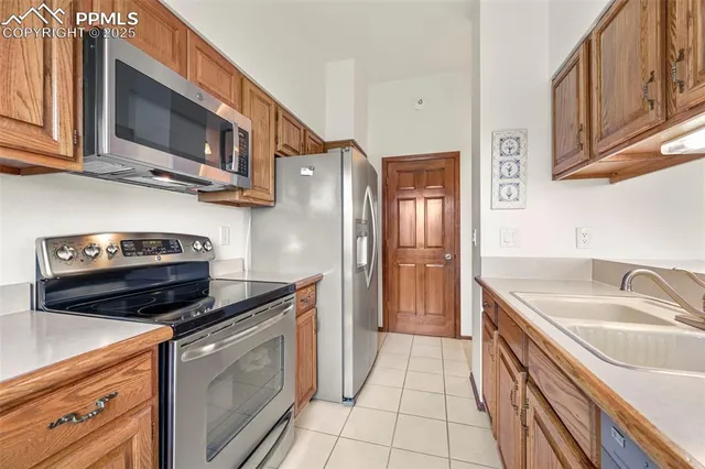a kitchen with stainless steel appliances granite countertop a sink stove and microwave