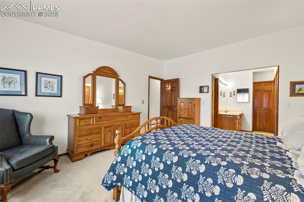 934 Fontmore Road, Unit C Colorado Springs, CO 80904 - Photo 24 of 37 a bedroom with a large bed and a dresser