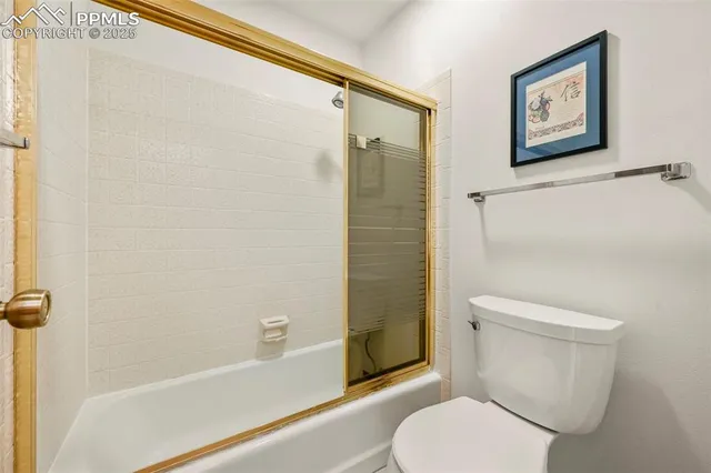 a white toilet sitting next to a bath tub