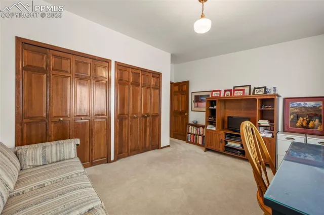 a bedroom with furniture and a chair