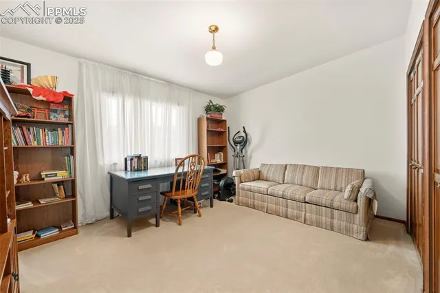 a living room with furniture and a book shelf