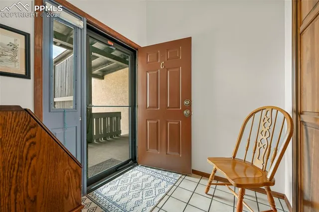 a view of a hallway with wooden floor and furniture