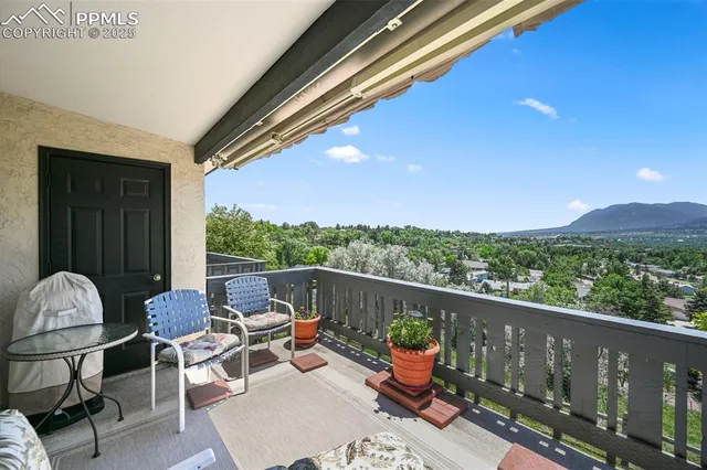 a view of a chairs and table in the balcony
