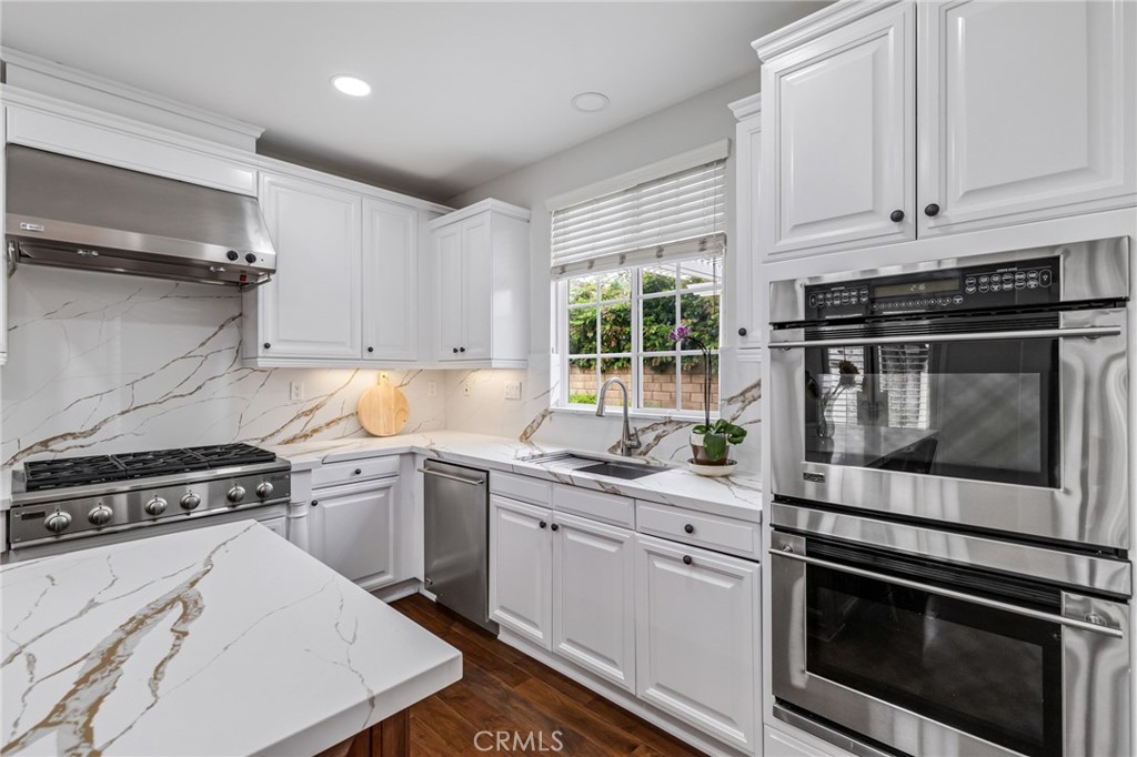 12 John Street Ladera Ranch, CA 92694 - Photo 12 of 37 a kitchen with stainless steel appliances white cabinets and a stove a oven