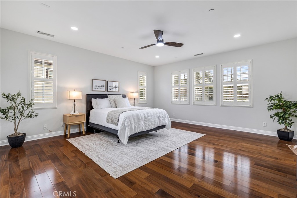 12 John Street Ladera Ranch, CA 92694 - Photo 19 of 37 a bedroom with a large bed chandelier and a window