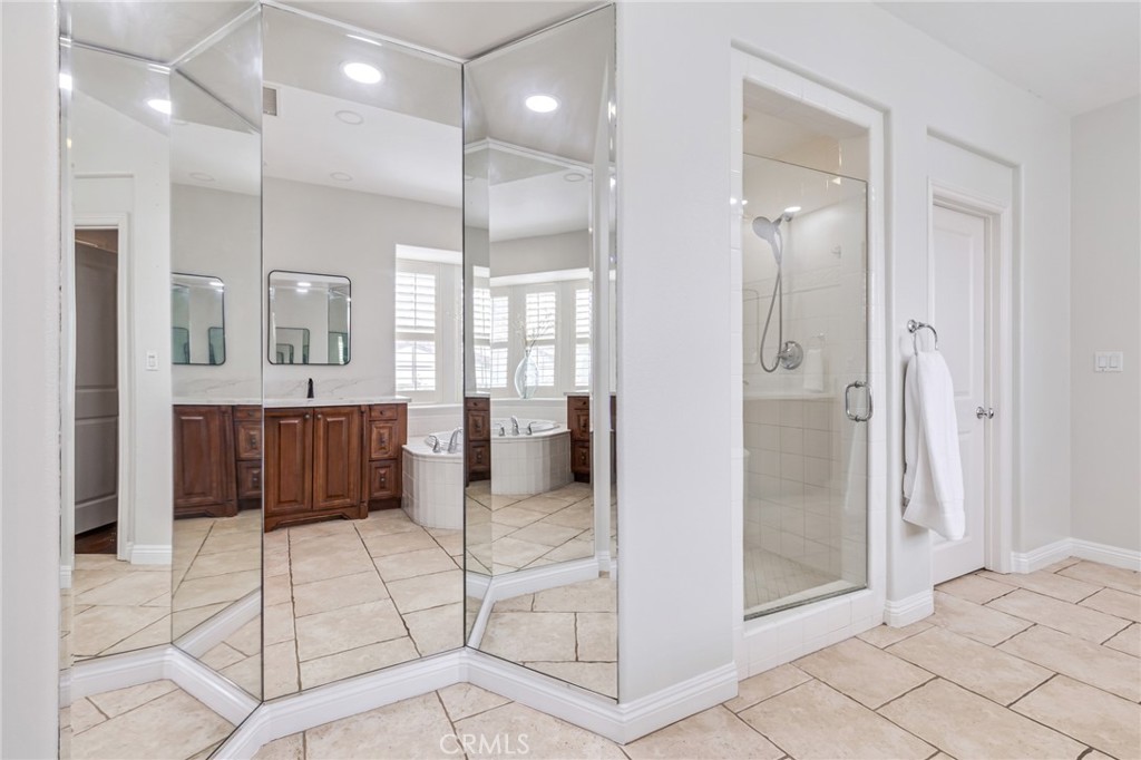 12 John Street Ladera Ranch, CA 92694 - Photo 21 of 37 a bathroom with a glass shower door a sink and a mirror