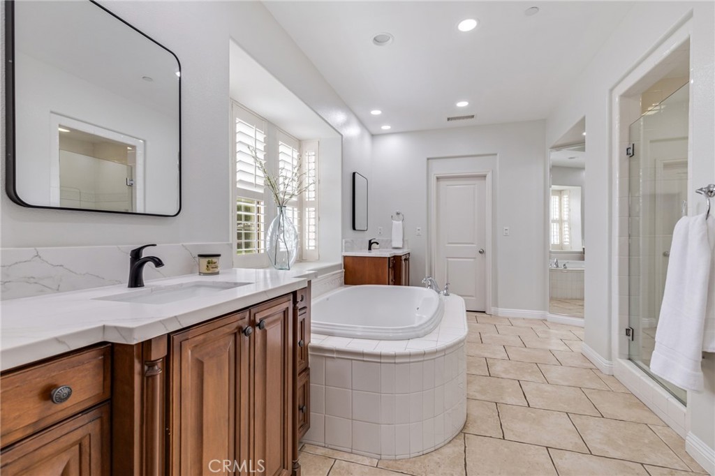 12 John Street Ladera Ranch, CA 92694 - Photo 22 of 37 a bathroom with a sink a toilet and mirror